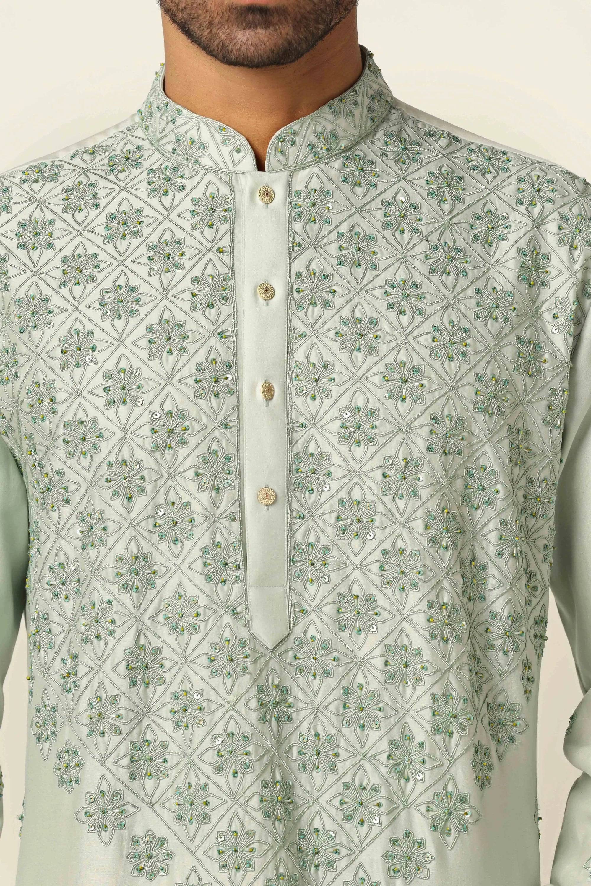 Floral thread embroidery adorns this kurta with off-white pajamas for a timeless ensemble. Shop Now!