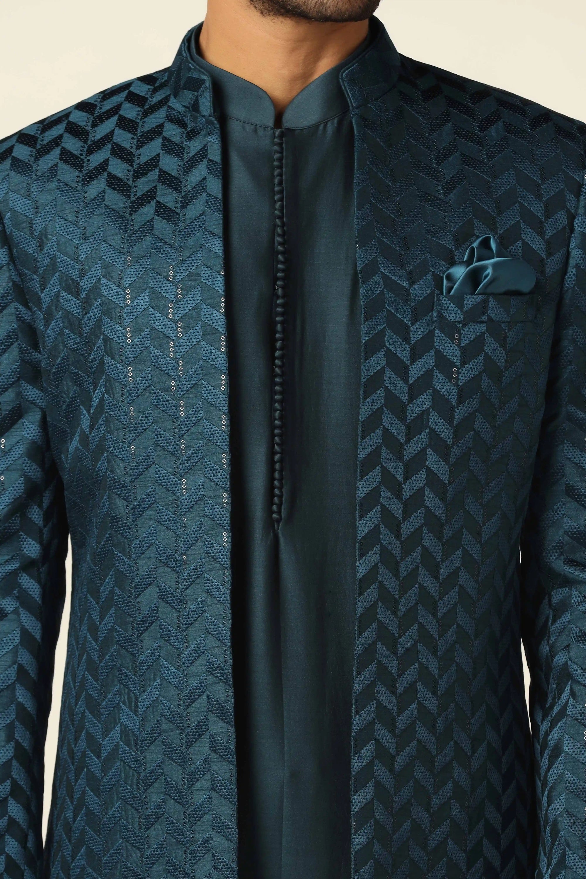 Elevate your style with a teal bandhgala suit, adorned with exquisite embroidery. Shop Now!