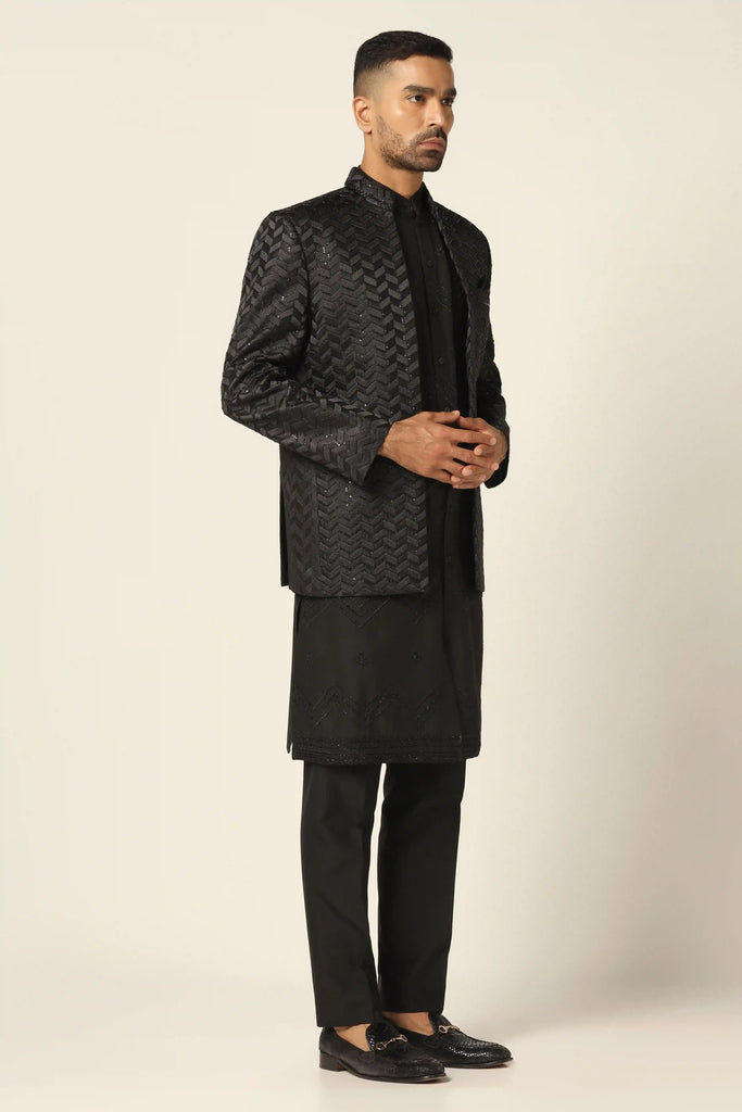 Elevate your style with our Indo-western set adorned with intricate machine embroidery. Paired with a matched Kurta and jet-black trousers for timeless elegance.