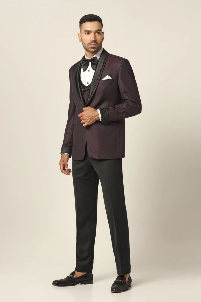 Elevate your style with our Wine Tuxedo. Satin shawl collar, subtle embroidery. Matching waistcoat in wine contrast fabric. Complete with Trousers.