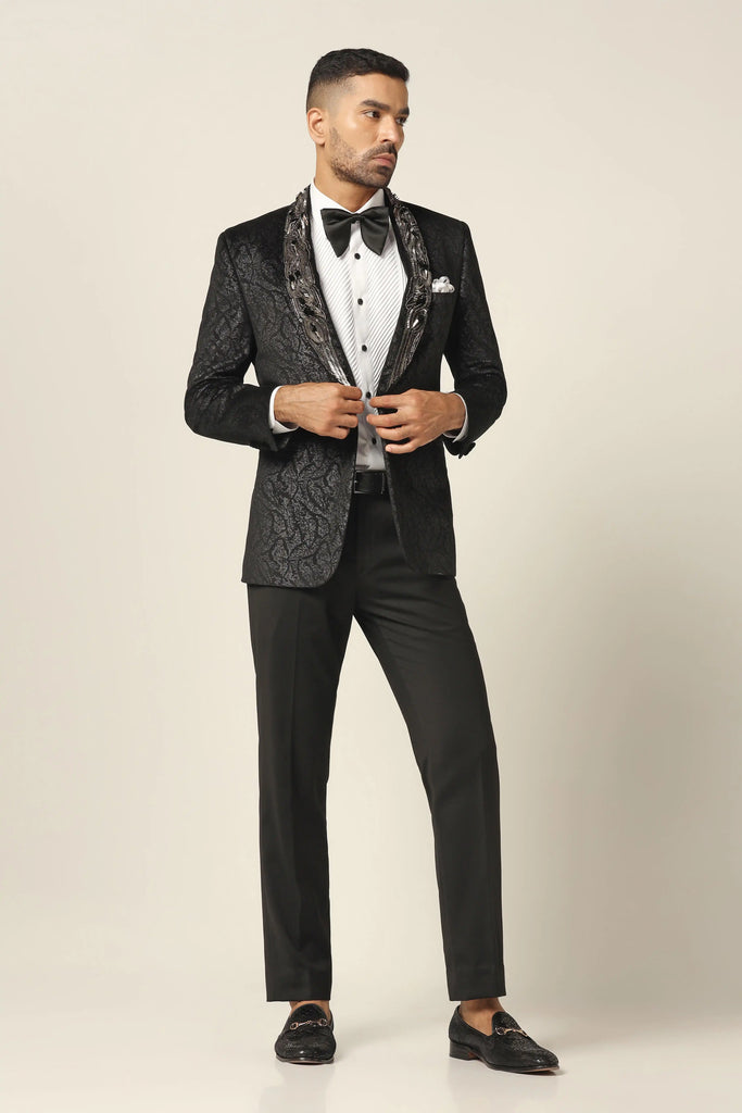 Classic elegance meets modern flair. Elevate your style with our black Tuxedo, featuring a sophisticated shawl collar and textured details. Complete the look with the matching Trouser.