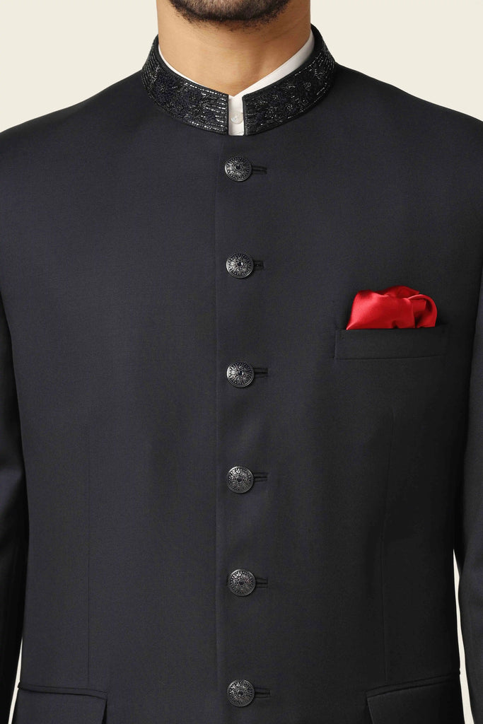 Dress with timeless elegance in our Navy Bandhgala suit, crafted from super fine wool fabric. Accentuated by subtle collar embroidery for a classic touch.
