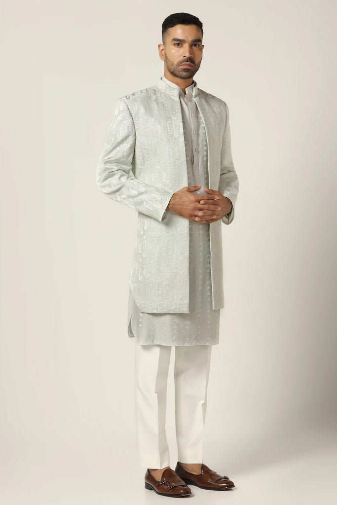 Dress in luxury with our raw silk Indo-western set, adorned with machine embroidery throughout. Paired seamlessly with a matching Kurta for a timeless look.
