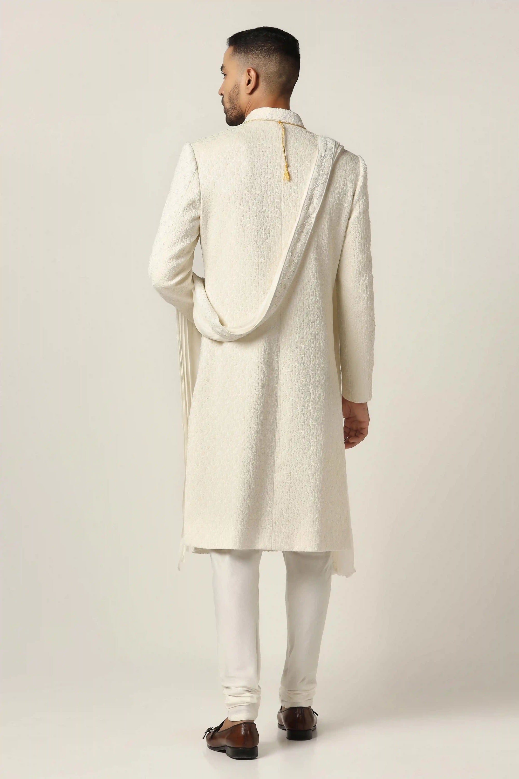 Drape in luxury with our Raw silk Sherwani set, intricately hand-embroidered throughout. Shop Now!
