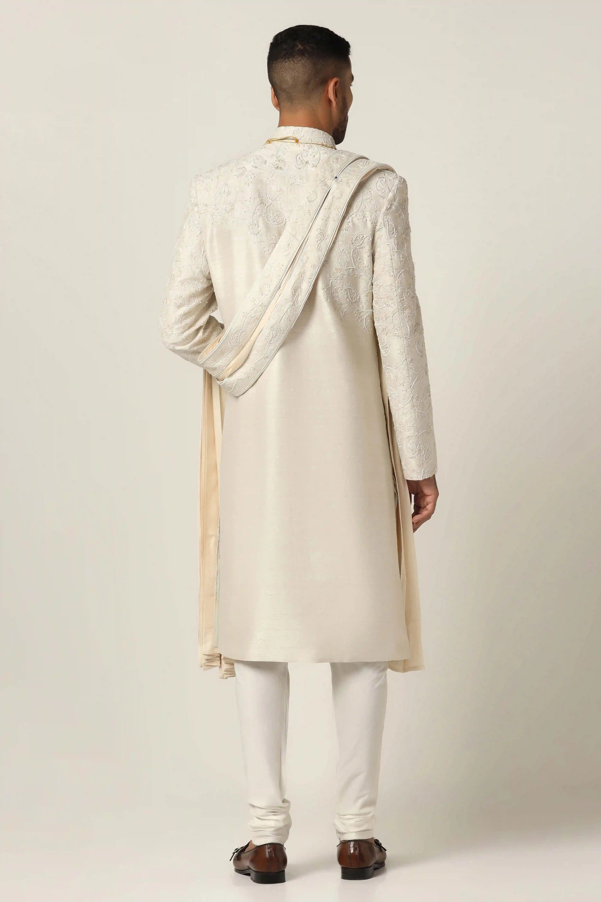 Indulge in luxury with our Raw silk Sherwani set, adorned with hand machine embroidery. Shop Now!