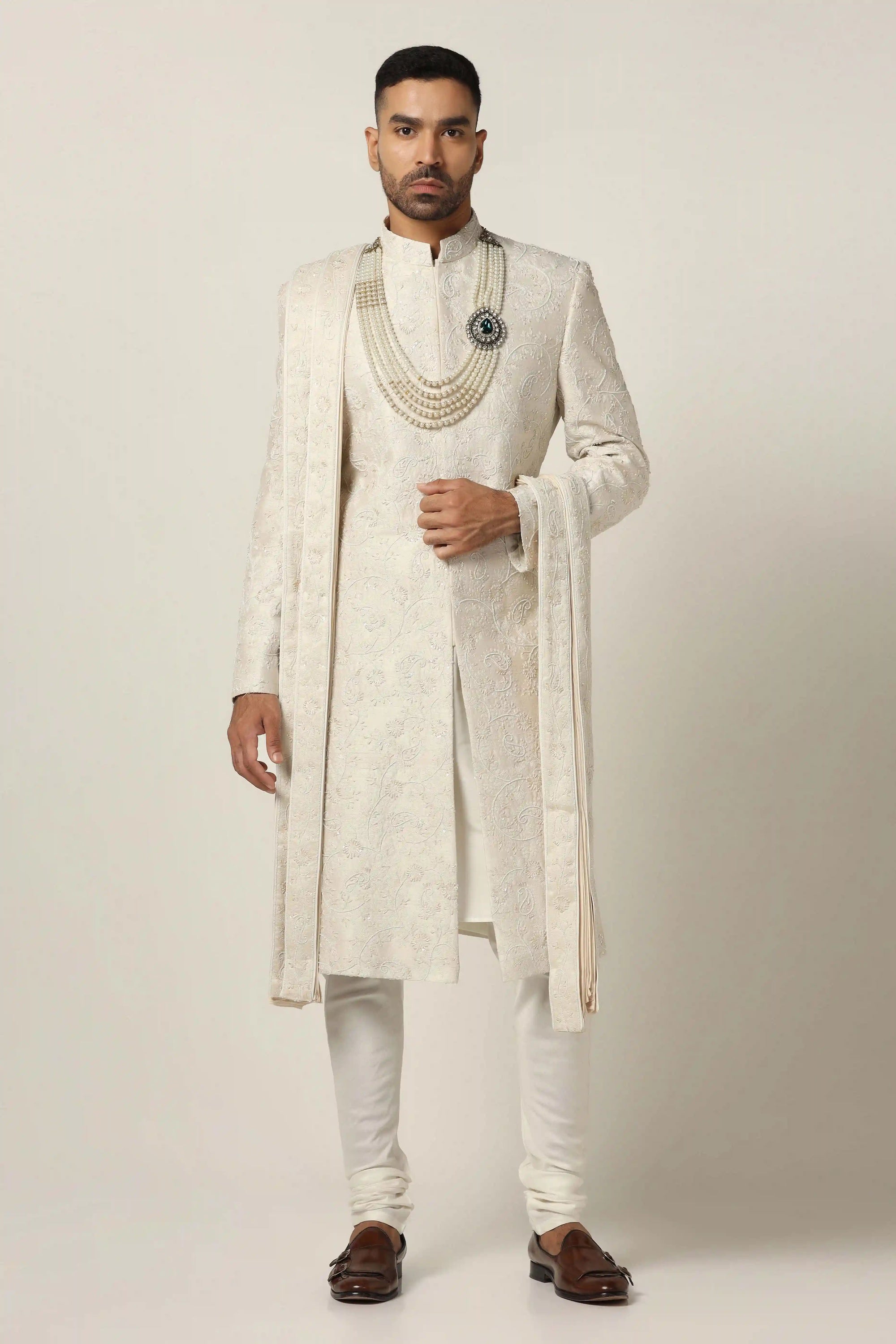Indulge in luxury with our Raw silk Sherwani set, adorned with hand machine embroidery. Shop Now!