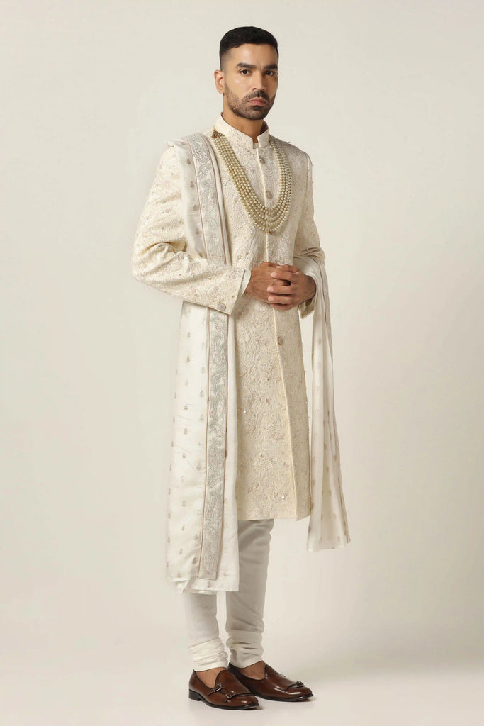 Elevate your style with our classic Sherwani featuring tonal white embroidery on the front & back. Complete with Kurta and Pajama ensemble.