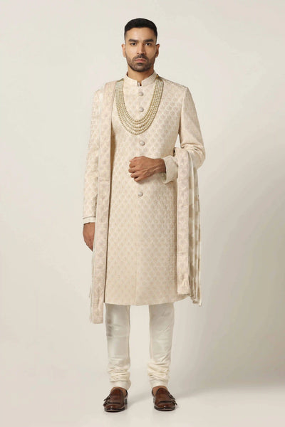 Elevate your style with our Raw silk Sherwani set, showcasing intricate geometric pattern embroidery. Complete with Kurta & Pajama for a refined look.