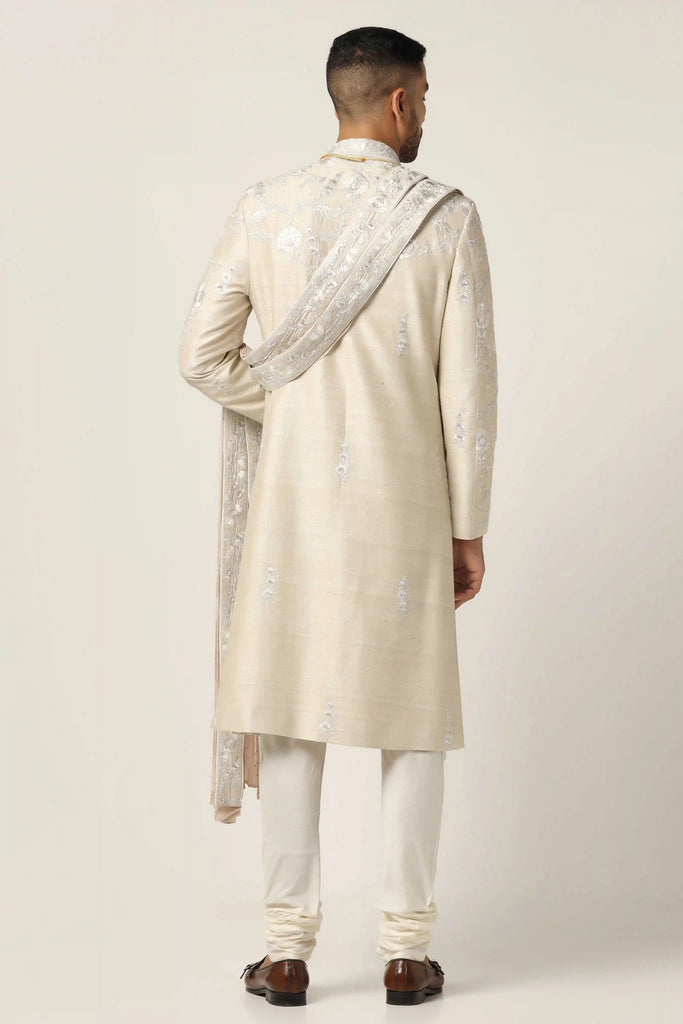 Crafted from premium Raw silk, this Sherwani set exudes elegance with intricate machine embroidery. Complete with a classic Kurta pajama ensemble for a timeless appeal.