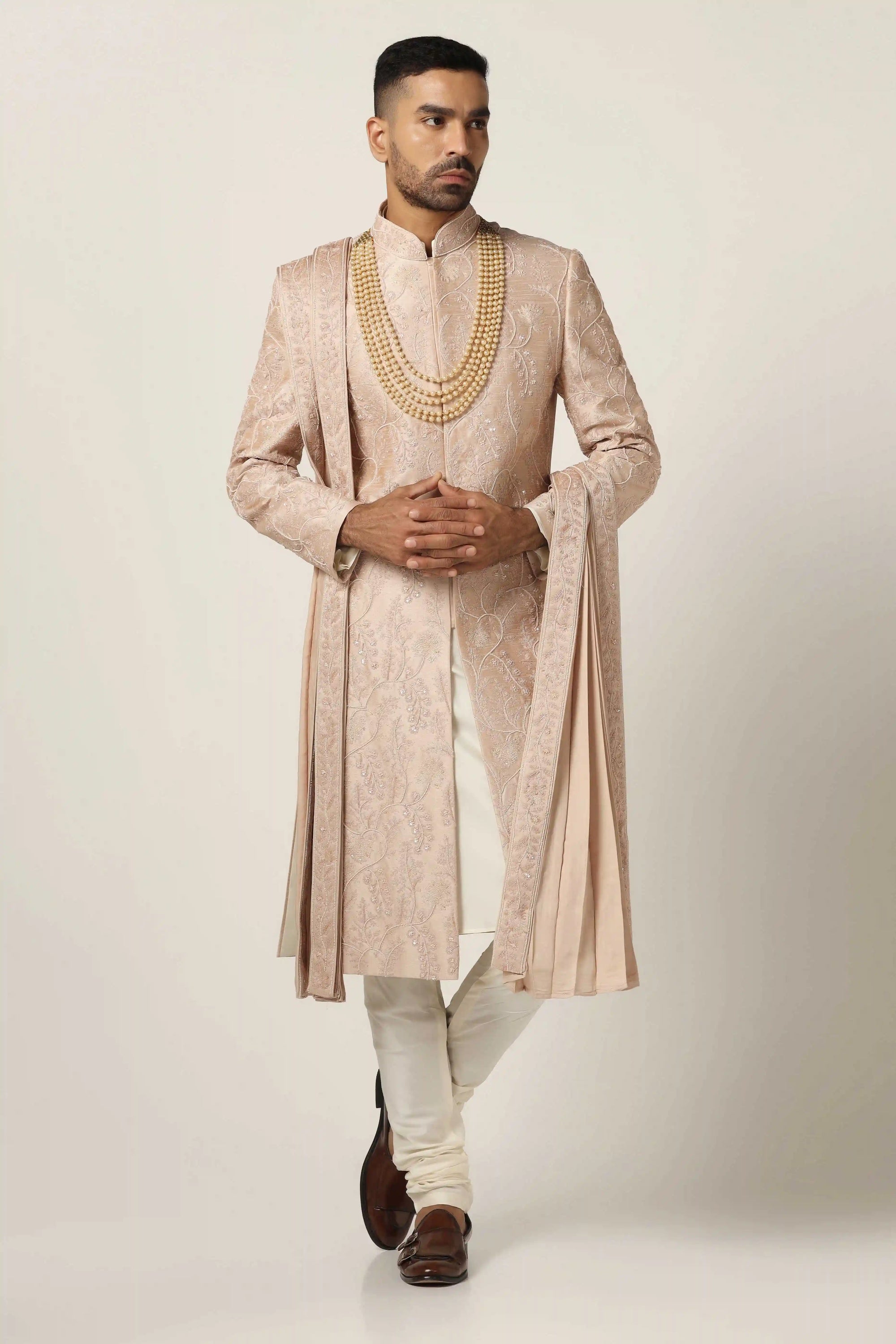 Elevate your style with Raw silk Sherwani set, adorned with intricate machine embroidery. Shop Now!