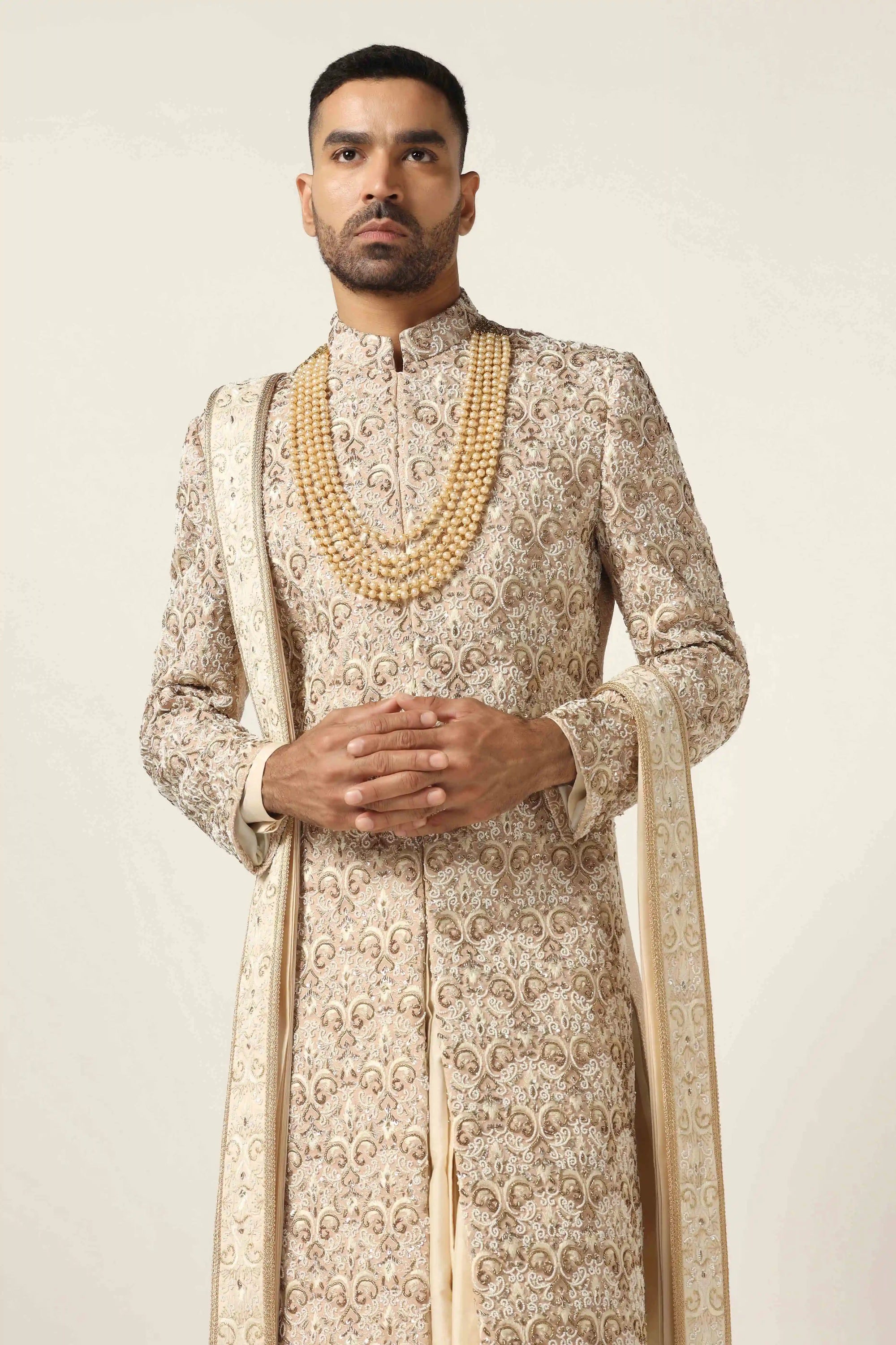 Elevate your style with our beige Sherwani, adorned with floral and geometric embroidery. Shop Now!