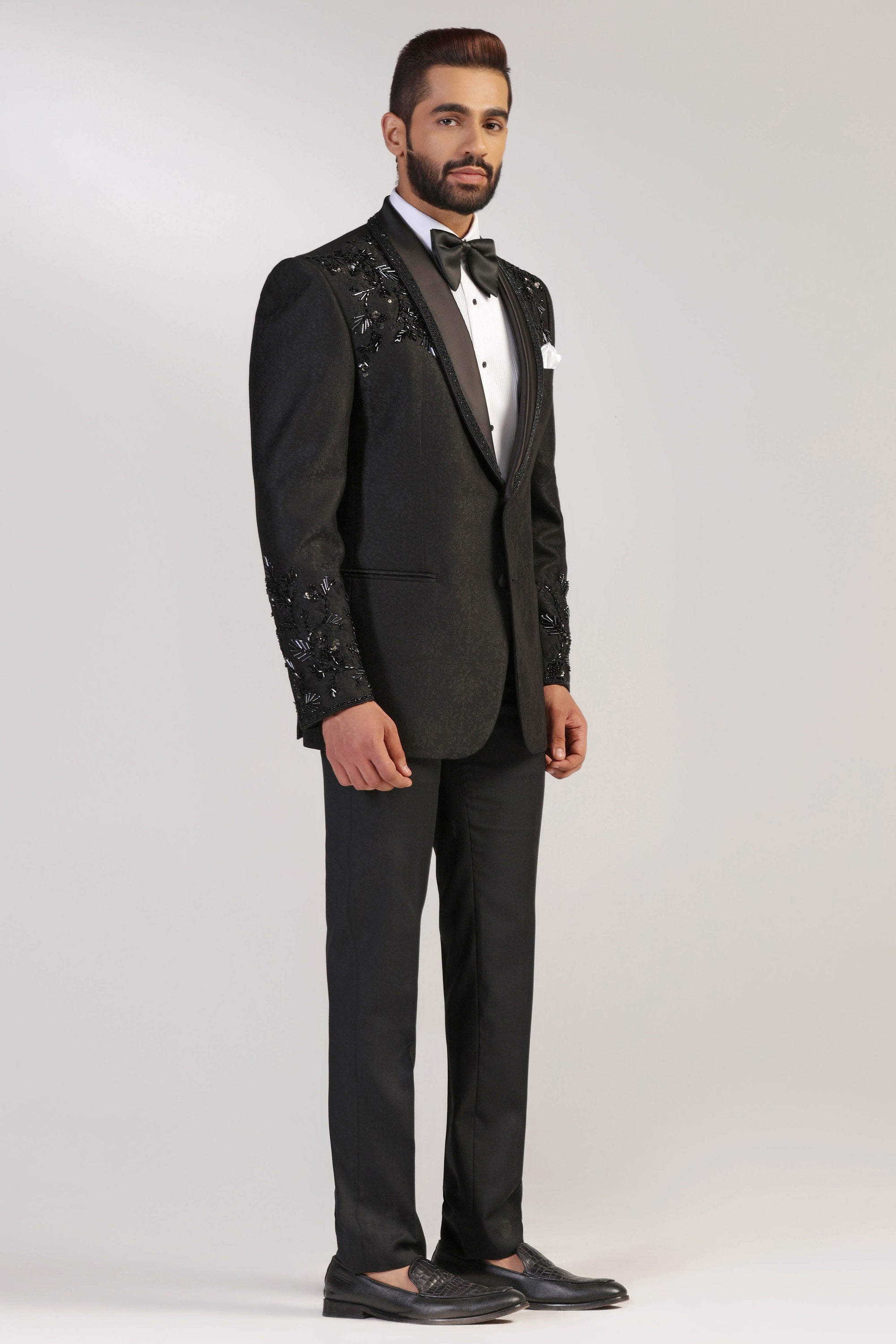 The Black Jacquard Tuxedo boasts a shawl collar with embroidery. Shop Now!