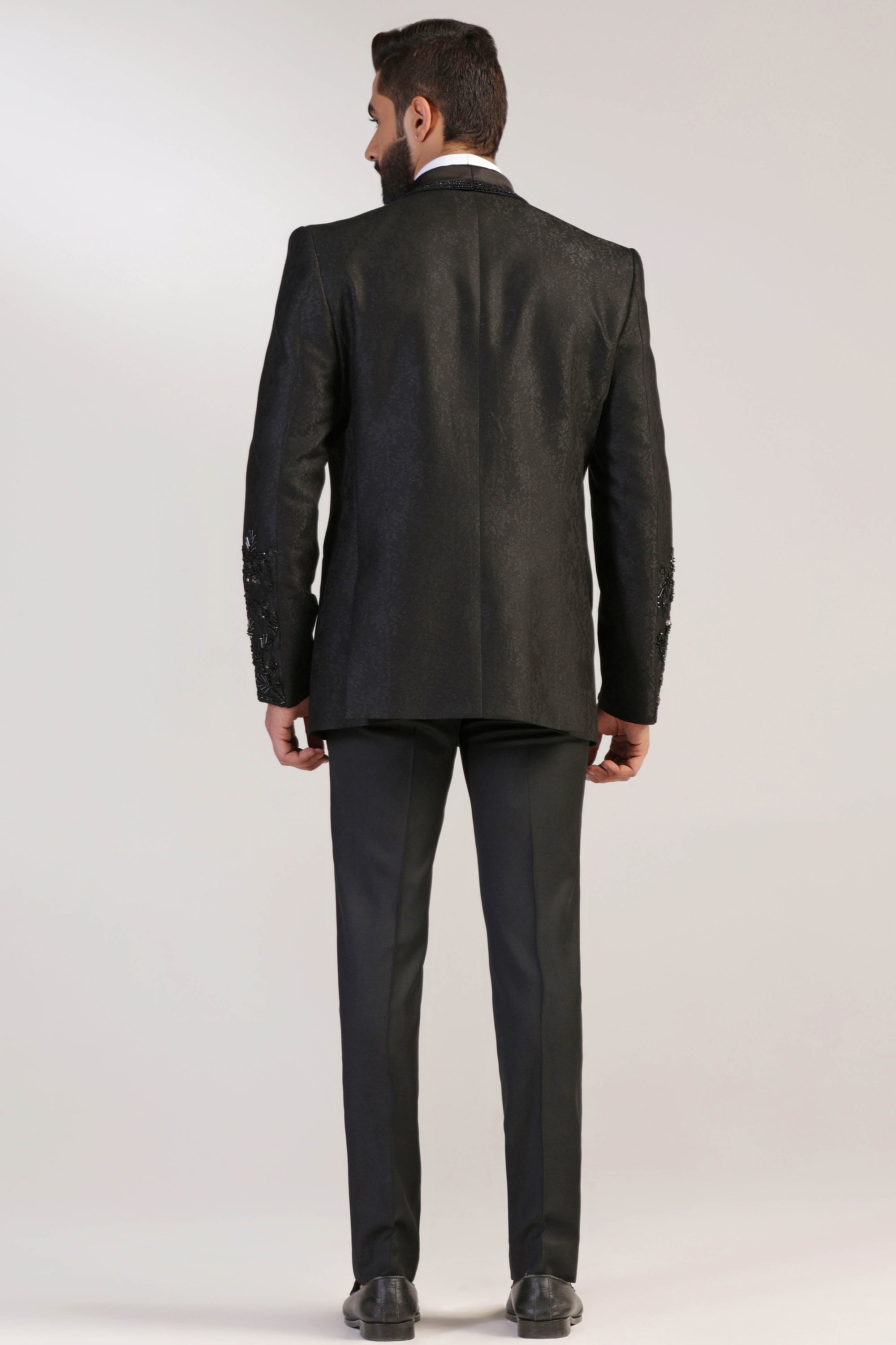 The Black Jacquard Tuxedo boasts a shawl collar with embroidery. Shop Now!