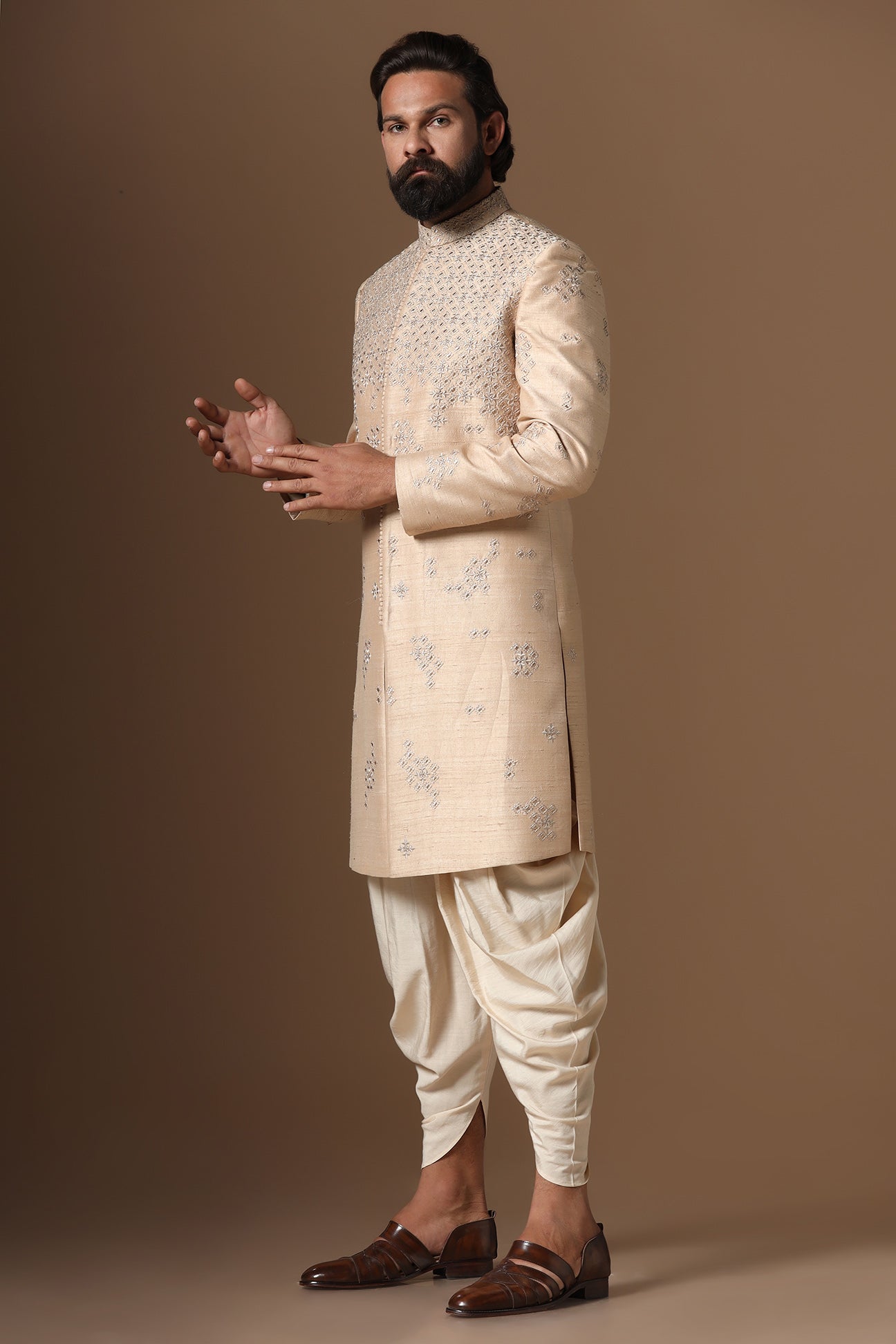 This beige Indo-Western made with raw silk fabric is highlighted by intricate embroidery. Shop Now!
