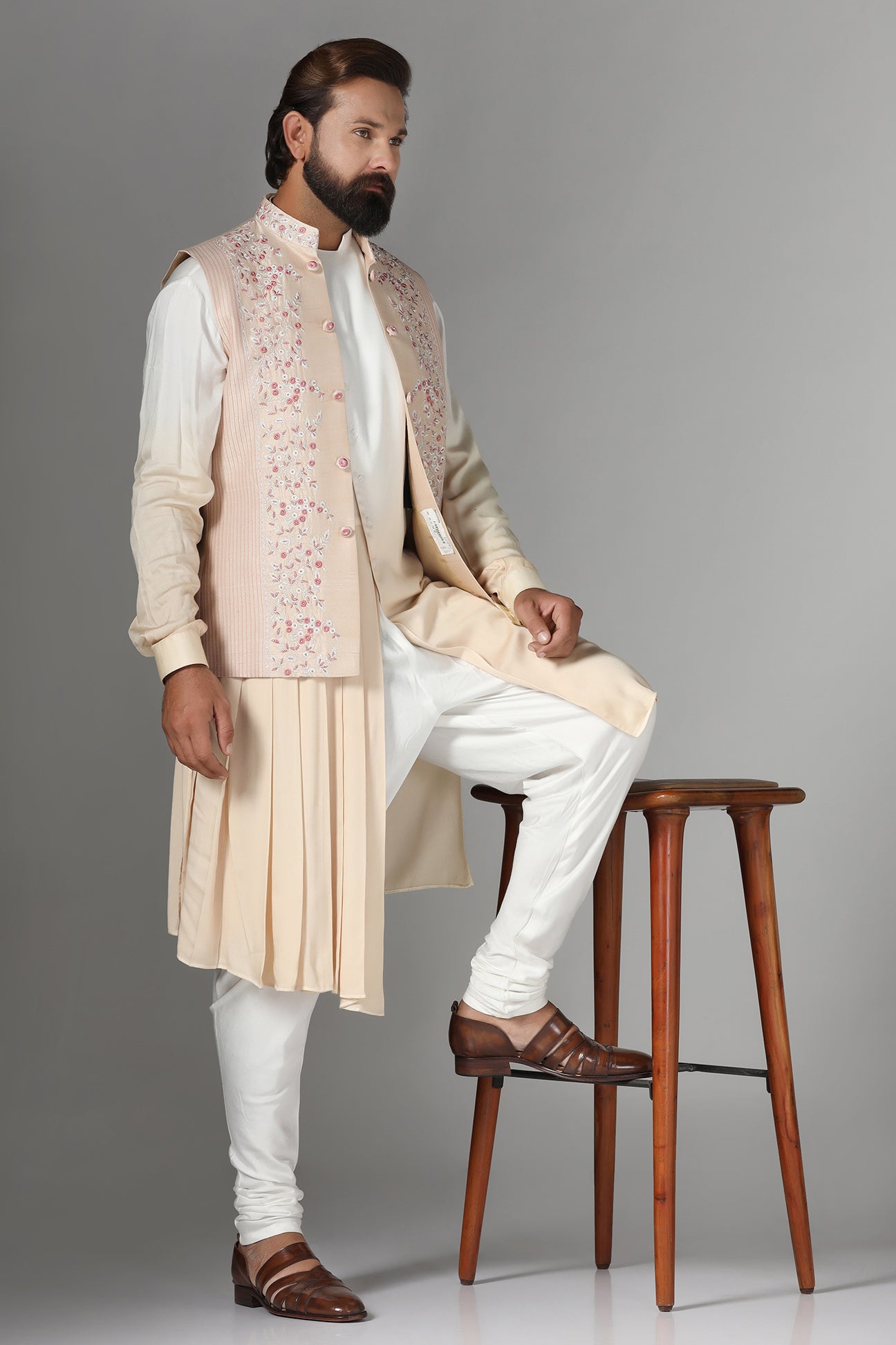 Elevate style with our light peach raw silk Nehru Jacket adorned with floral embroidery. Shop Now!