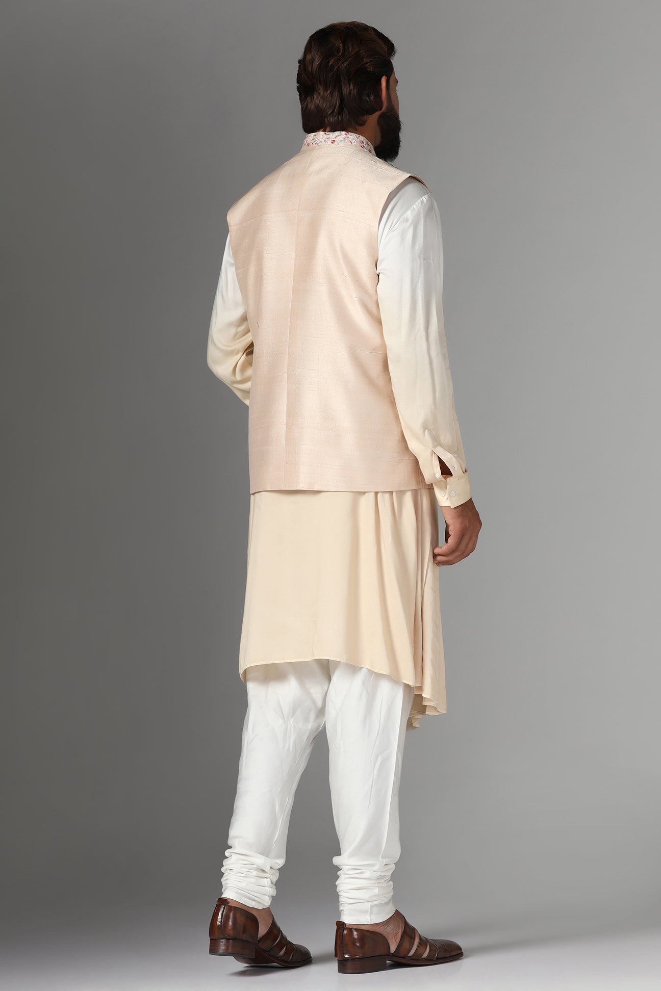 Elevate style with our light peach raw silk Nehru Jacket adorned with floral embroidery. Shop Now!