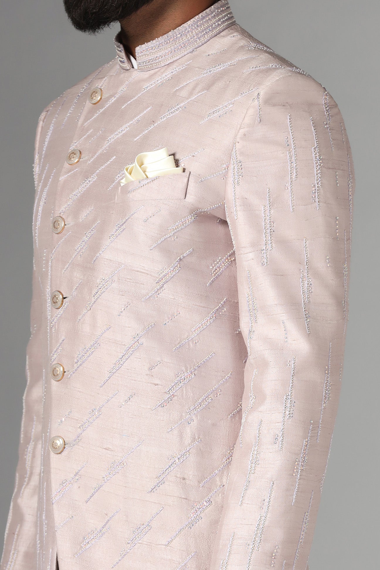Shop the elegant pink Bandhgala suit with an asymmetric design. Shop now!