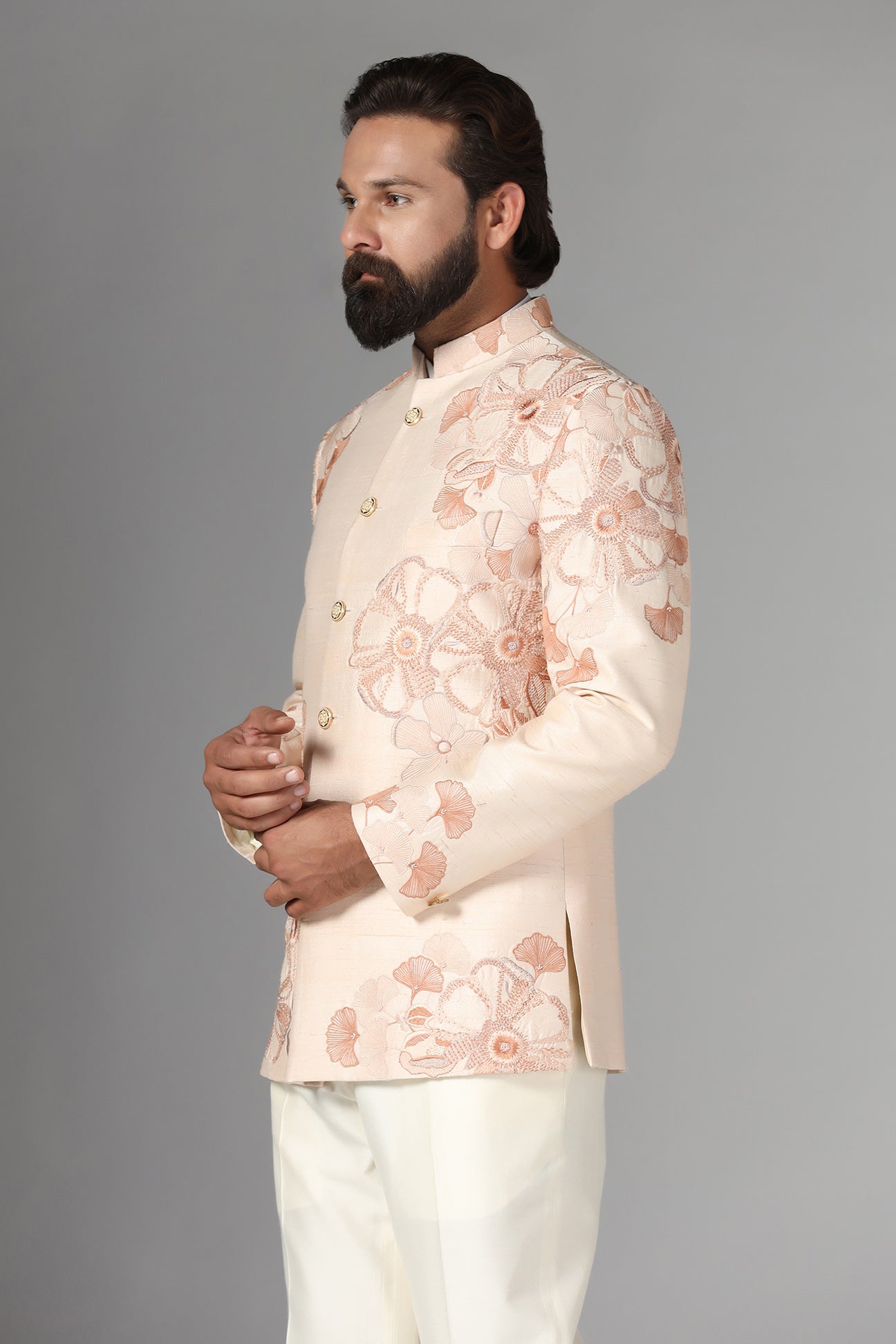 Dress in sophistication with our light peach Bandhgala suit in raw-silk fabric. Shop Now!