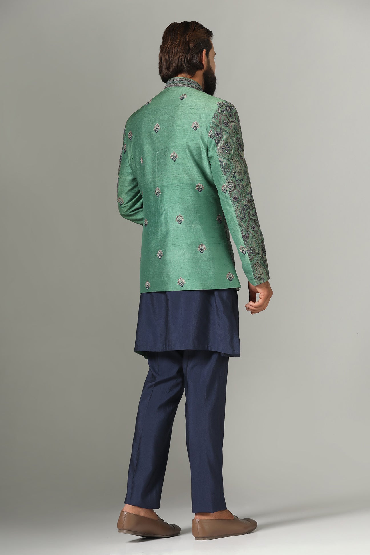 Shop the stylish green Bandhgala suit with intricate embroidery for a refined look. Shop now!