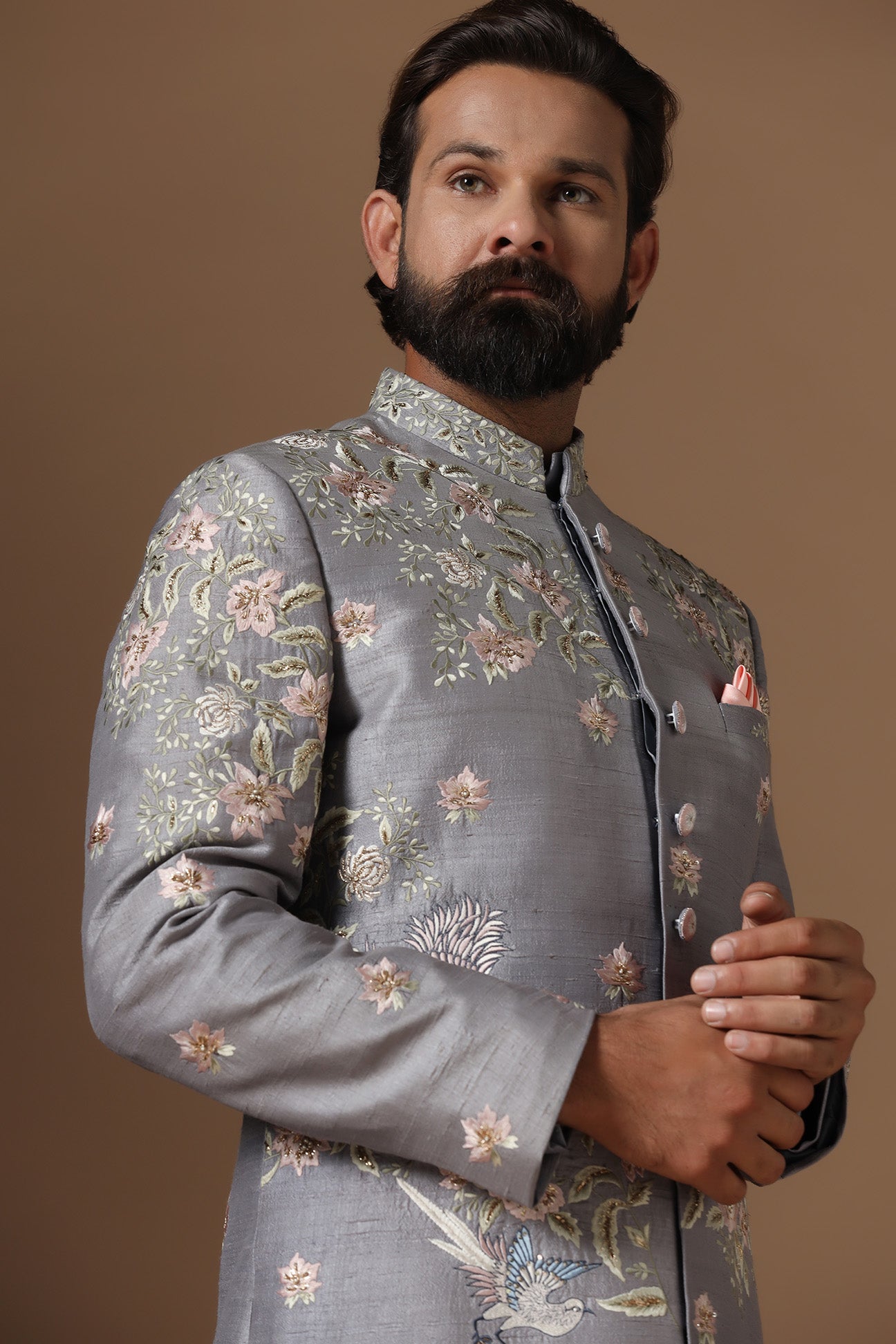 This grey Indowestern is highlighted with floral motif embroidery. Shop Now!