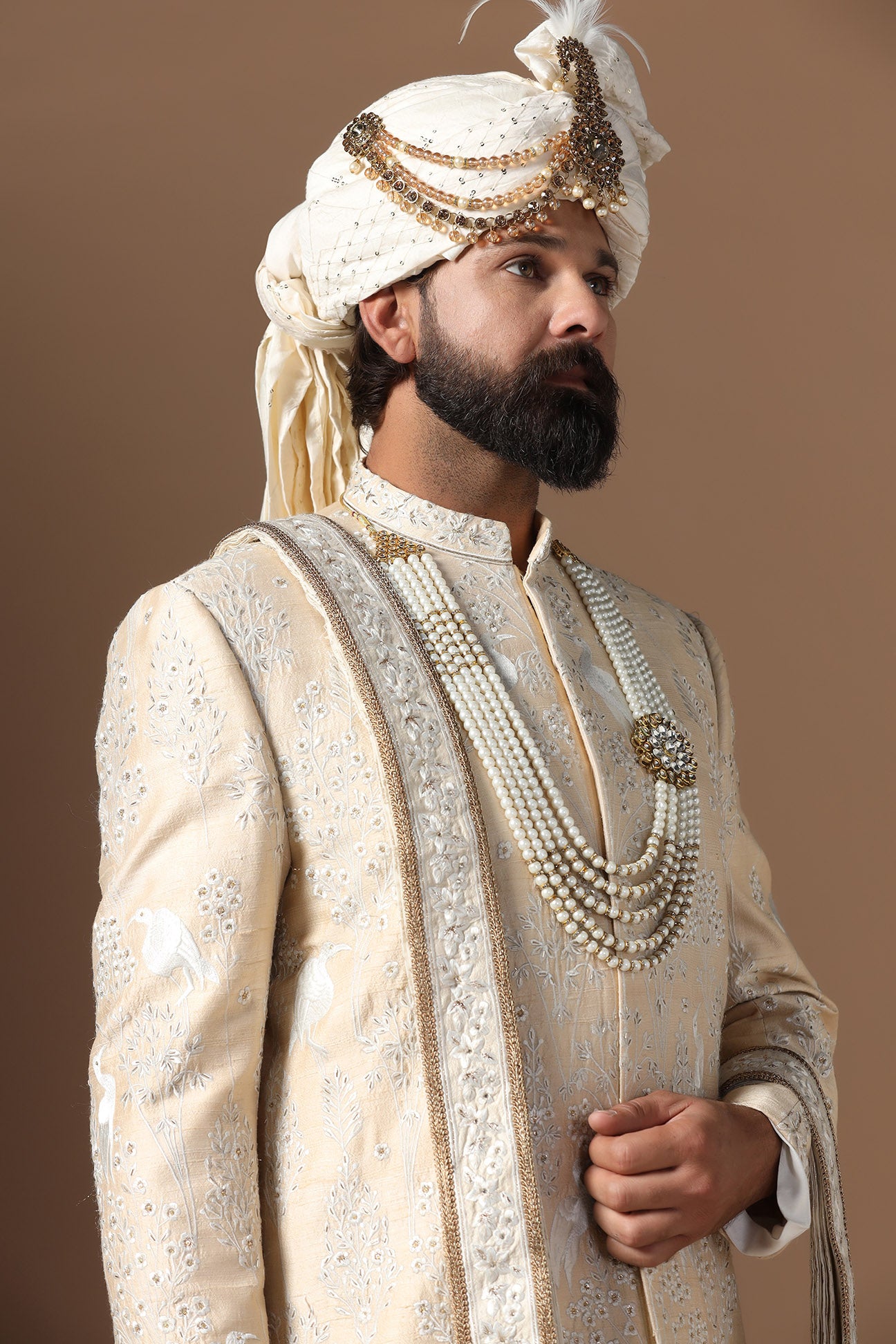 Elevate your style with our beige sherwani with intricate floral and bird embroidery. Shop Now!