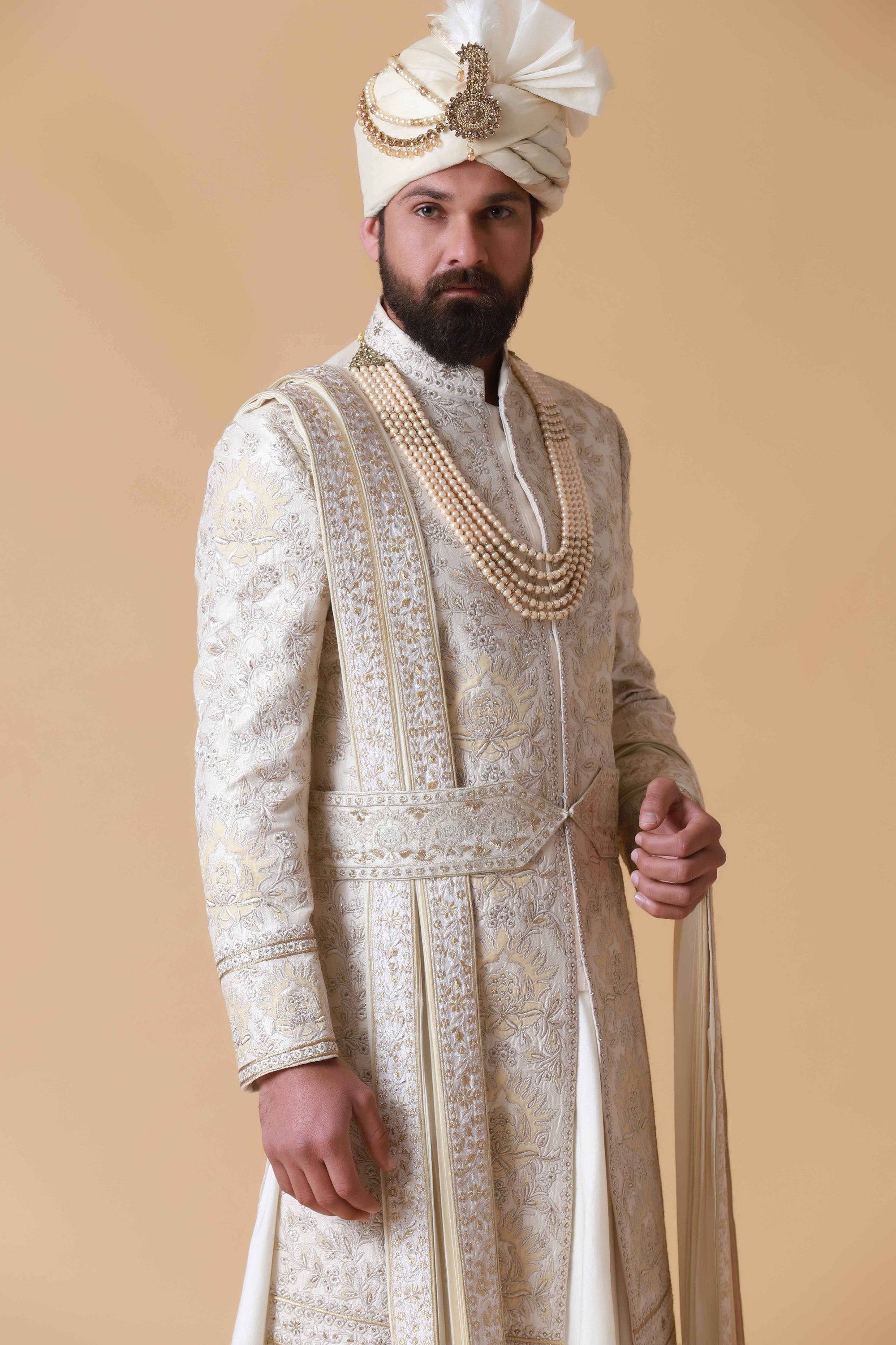 Exude regal elegance in this off-white Sherwani crafted from raw silk. Shop Now!