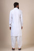 Crafted in flowing modal fabric, this White pathani suit exudes traditional charm with its collared neck, double chest pockets, and shoulder flaps.