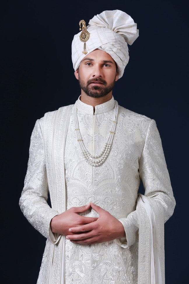 Timeless elegance embodied in this ivory Sherwani, adorned with tonal white embroidery. Shop Now!