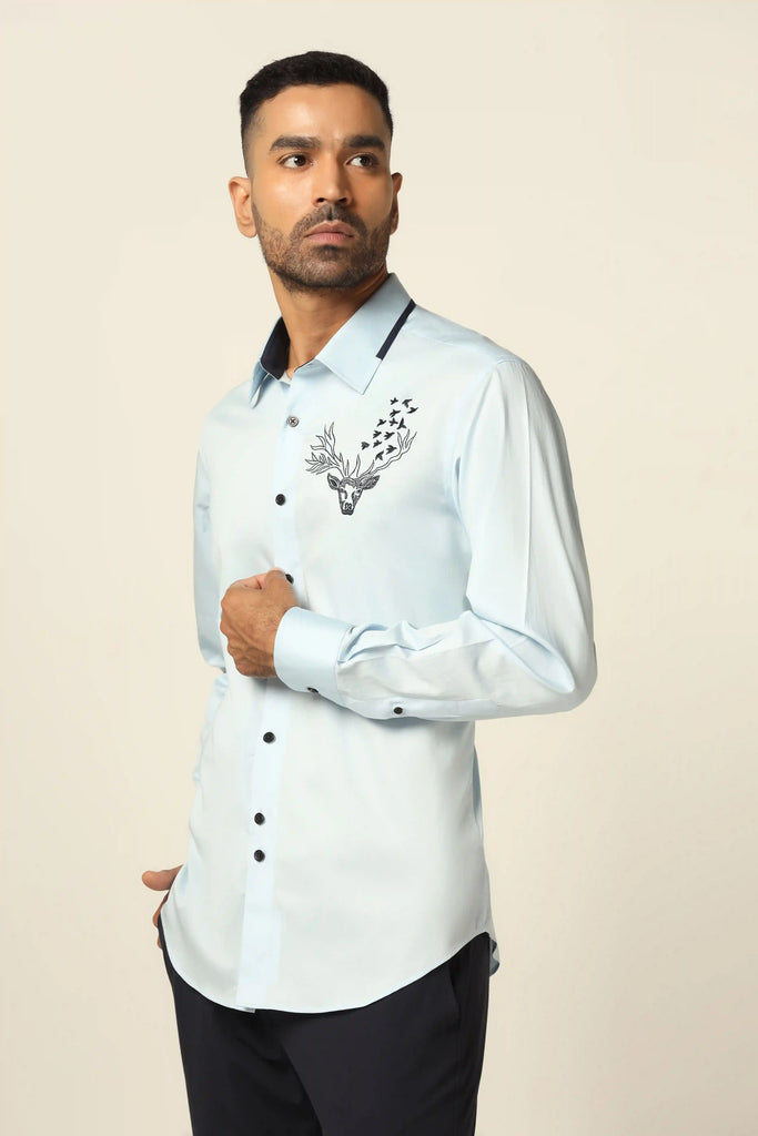 Indulge in luxury with our designer shirt crafted from 100% Giza cotton. Adorned with floral embroidery on the left chest and contrast paneling on the collar.