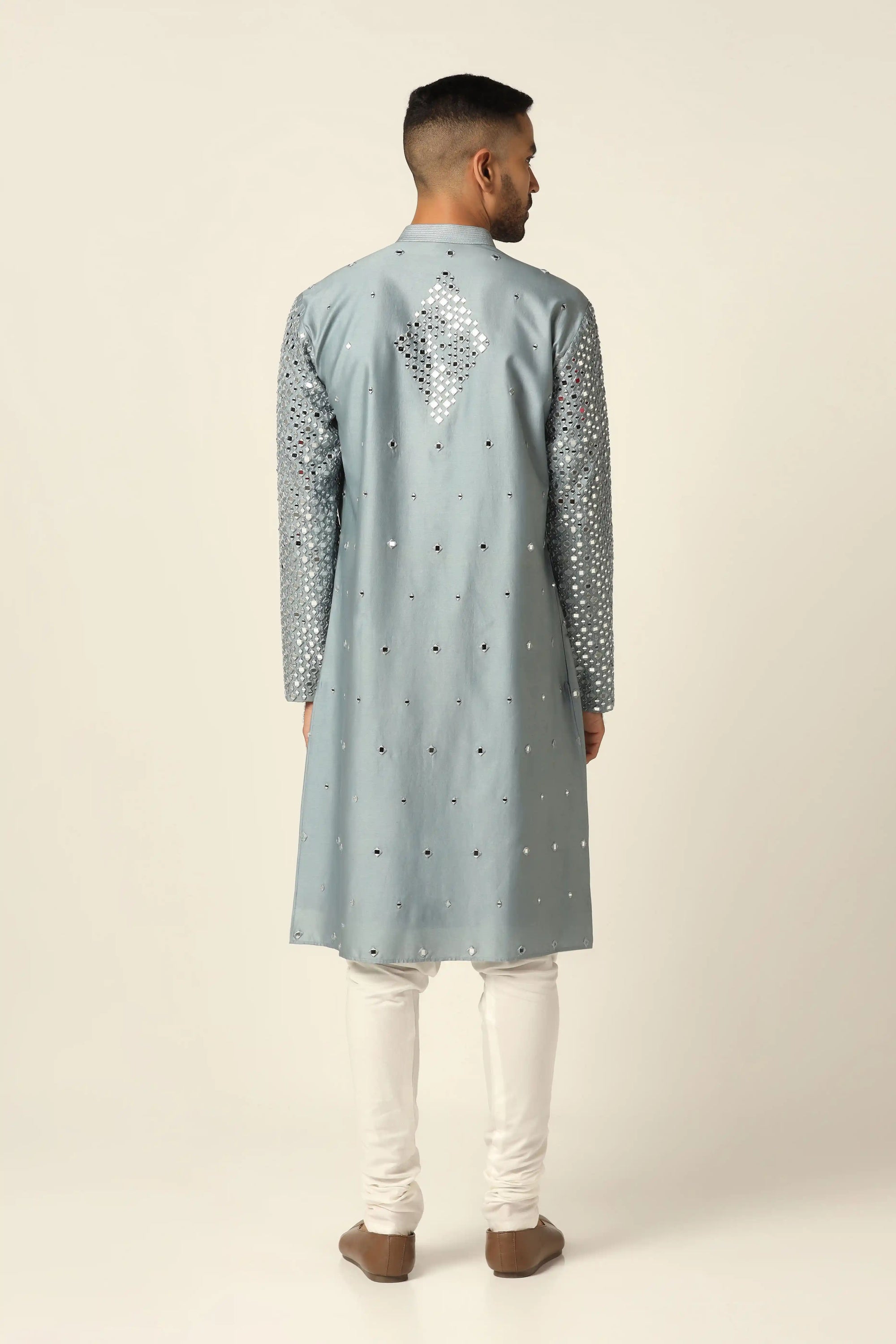 This Chanderi silk Kurta Pajama set features elegant mirror work and thread embroidery. Shop Now!