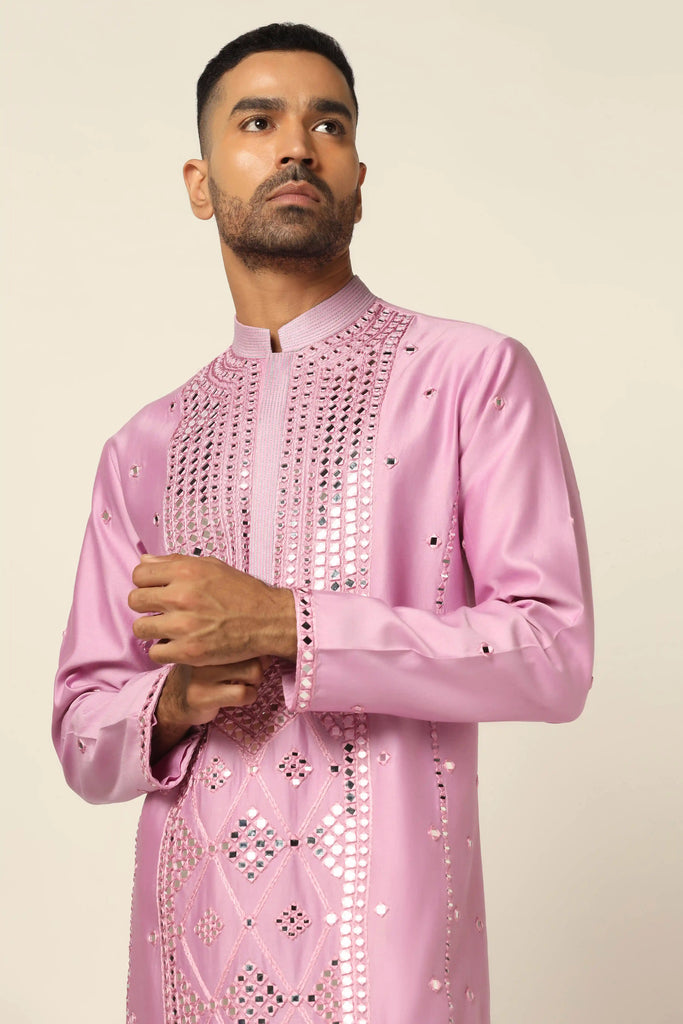 Elevate your style with mirrorwork magic. This Chanderi silk Kurta features intricate mirrorwork embroidery, paired perfectly with off-white pajamas.