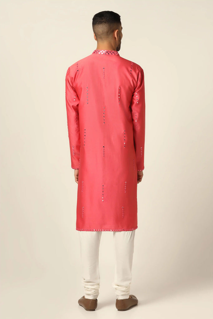 Indulge in luxury with our Chanderi silk Kurta Pajama set. Adorned with exquisite mirror embroidery, this ensemble exudes sophistication. Paired with off-white churidar pajamas for a timeless appeal.