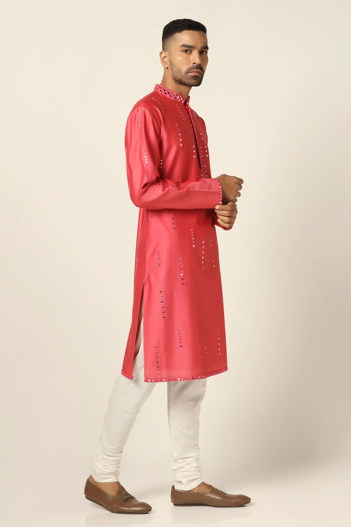 Indulge in luxury with our Chanderi silk Kurta Pajama set. Adorned with exquisite mirror embroidery, this ensemble exudes sophistication. Paired with off-white churidar pajamas for a timeless appeal.