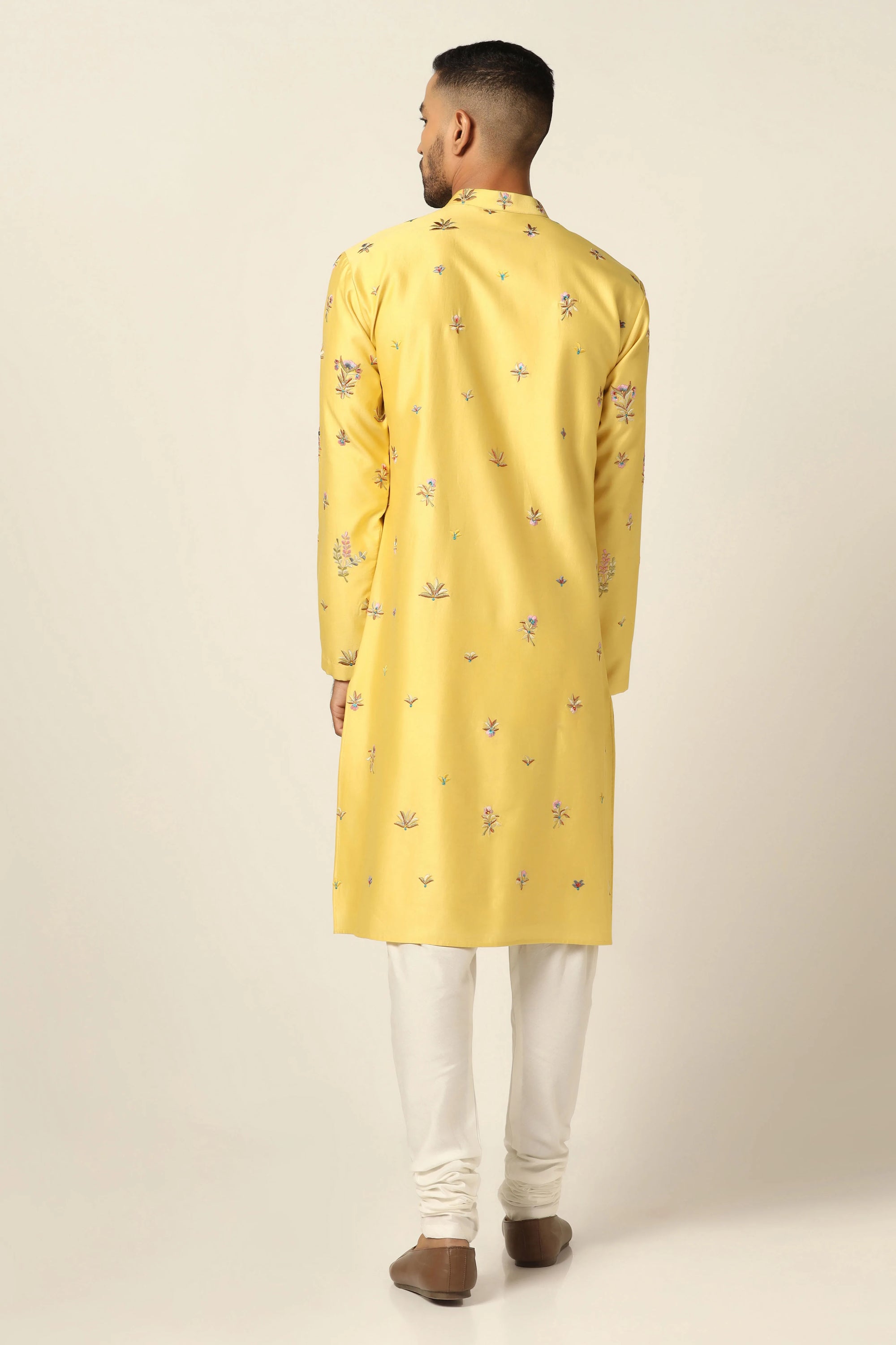 This Kurta Pajama set features vibrant floral motifs adorning the yellow kurta. Shop Now!