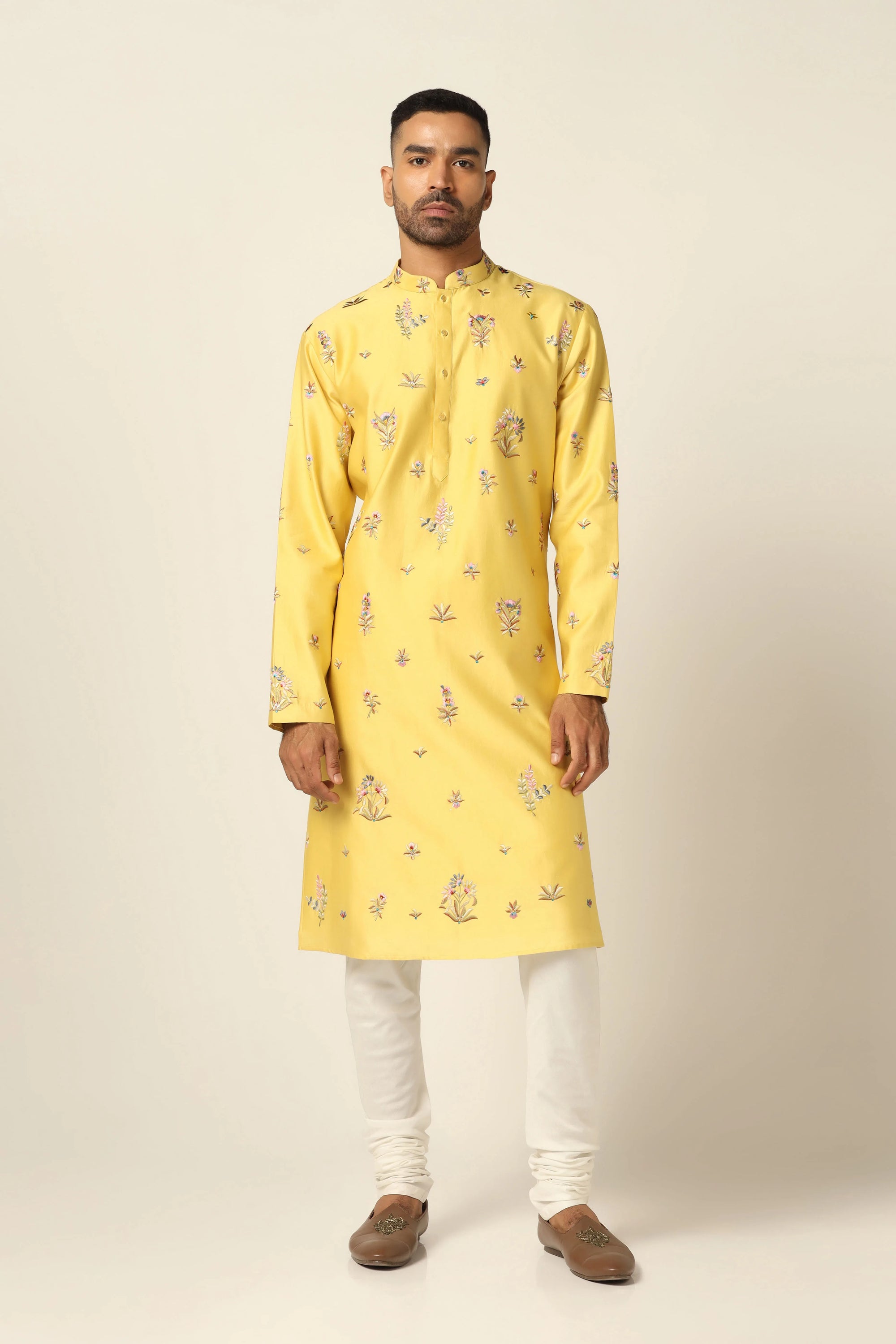 This Kurta Pajama set features vibrant floral motifs adorning the yellow kurta. Shop Now!