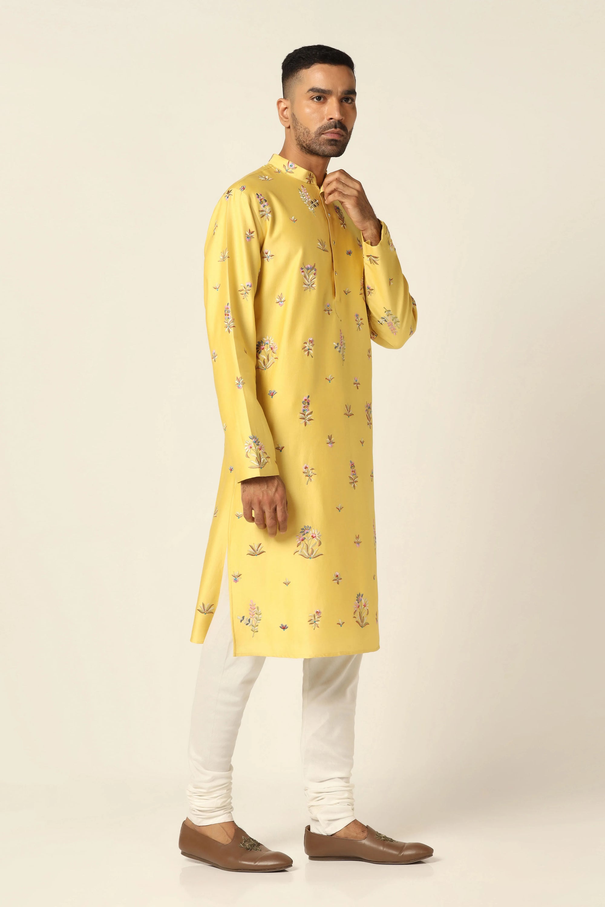 This Kurta Pajama set features vibrant floral motifs adorning the yellow kurta. Shop Now!