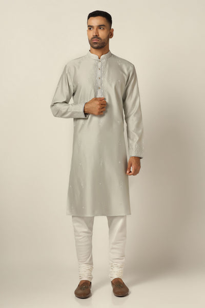 Dress in exquisite style with our Chanderi Silk kurta pajama set, featuring intricate thread/machine embroidery throughout. Complete with matching white pajamas for a refined ensemble.