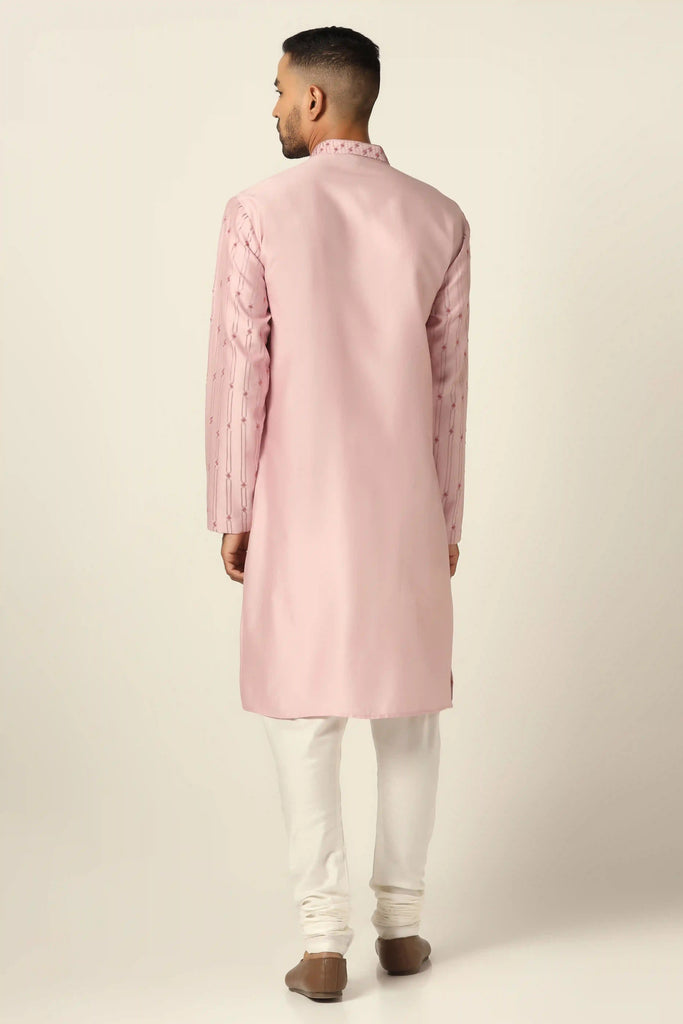 Elevate your style with this Chanderi Silk kurta pajama set. The pink kurta features tonal geometric embroidery, paired perfectly with off-white pajamas for a sophisticated look.