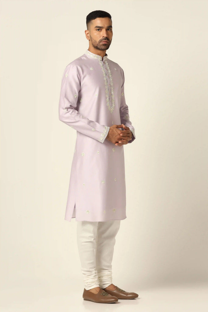 Experience sophistication in our chanderi silk Kurta set, adorned with intricate thread/machine embroidery. Paired with matching golden pajamas for a refined and elegant ensemble.