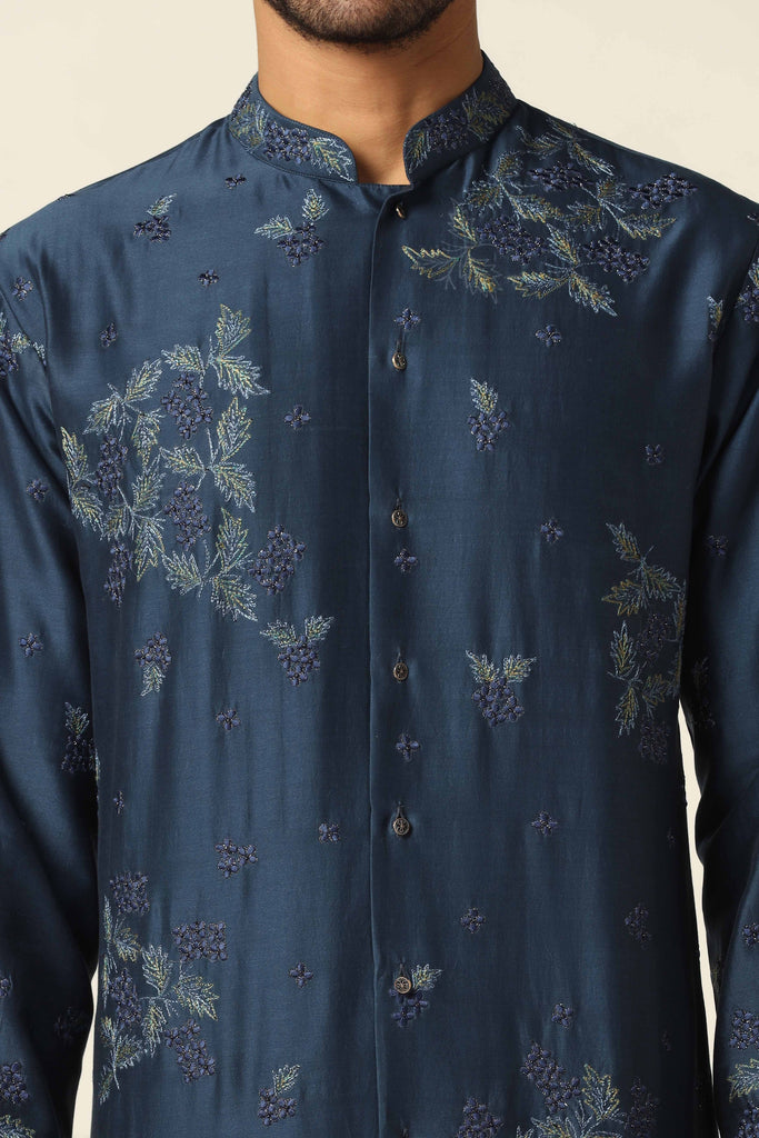 Dress in elegance with our Navy Kurta, adorned with floral thread embroidery. Featuring a front open design, paired perfectly with matching off-white pajamas.