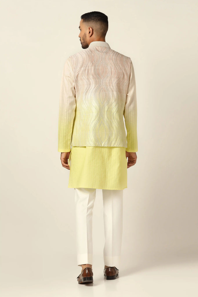 Indulge in elegance with our embroidered Nehru Jacket set, blending yellow and peach hues. Adorned with machine embroidery, paired with off-white pajamas for a refined look."