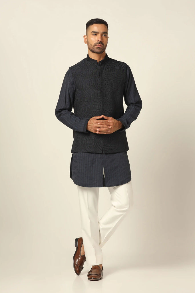 Adorned with exquisite machine & hand embroidery, our Nehru Jacket set exudes elegance. Paired with a matching Kurta and white Trousers for timeless style.