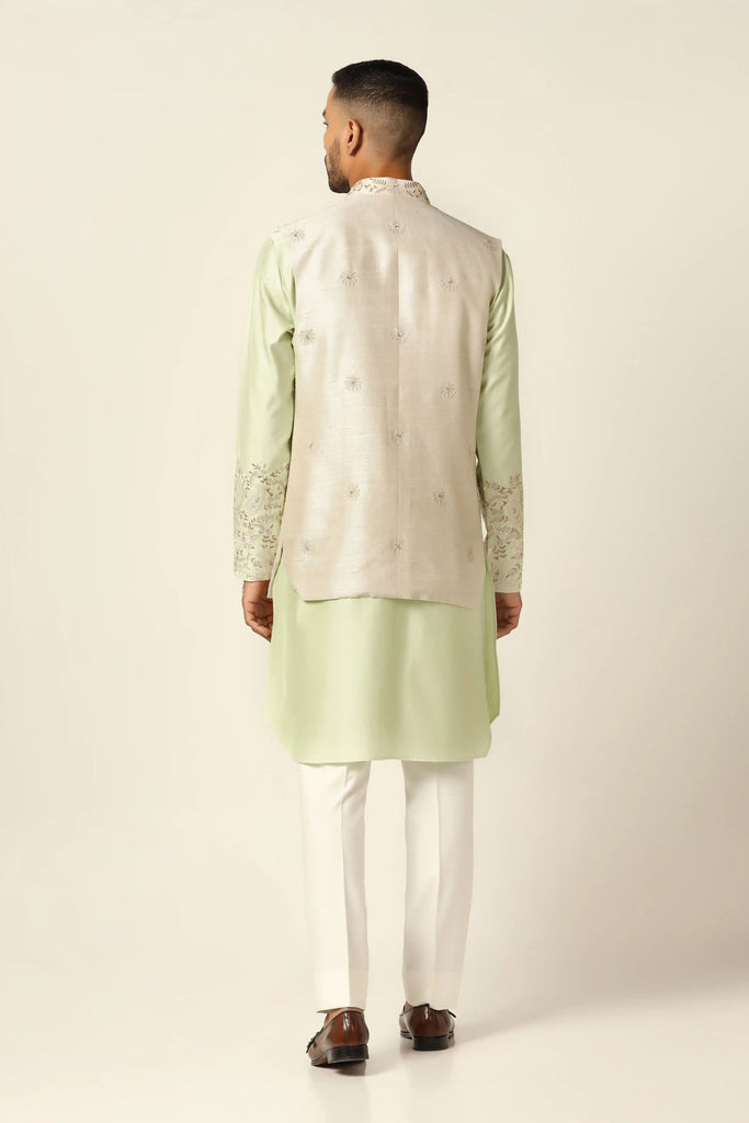Elevate your look with our Nehru Jacket adorned with floral embroidery. Paired seamlessly with a matching kurta and white pajamas for timeless style.