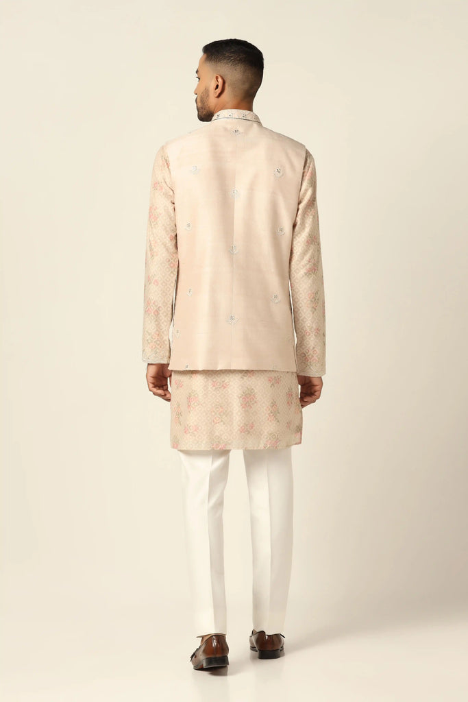 Elevate your style with our Nehru Jacket featuring geometric embroidery. Paired with a printed blocked kurta and white pajamas for a refined ensemble.