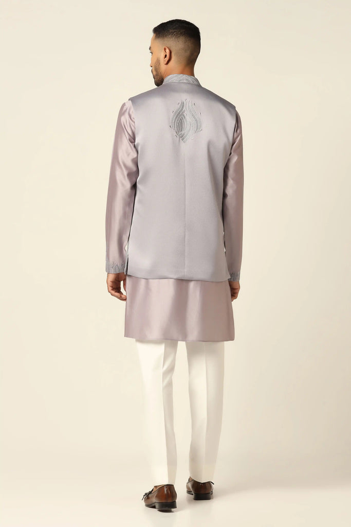 Experience elegance with our Nehru set featuring intricate thread embroidery on the jacket front. Complete with a matching kurta and off-white trousers for refined style.