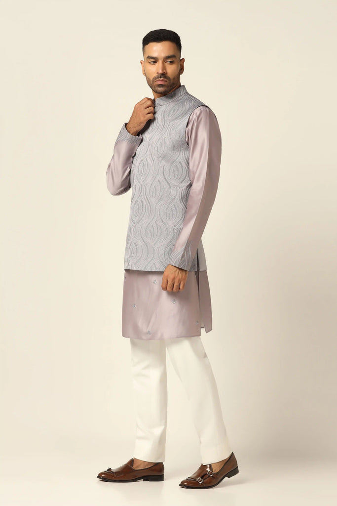 Experience elegance with our Nehru set featuring intricate thread embroidery on the jacket front. Complete with a matching kurta and off-white trousers for refined style.