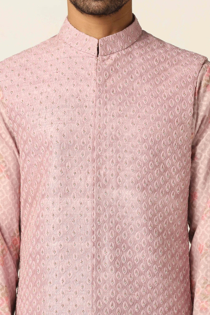 Elevate your ensemble with our Peach Nehru Jacket adorned with subtle geometric thread and pearl embroidery. Paired with a blocked printed Kurta and off-white pajamas for refined elegance.