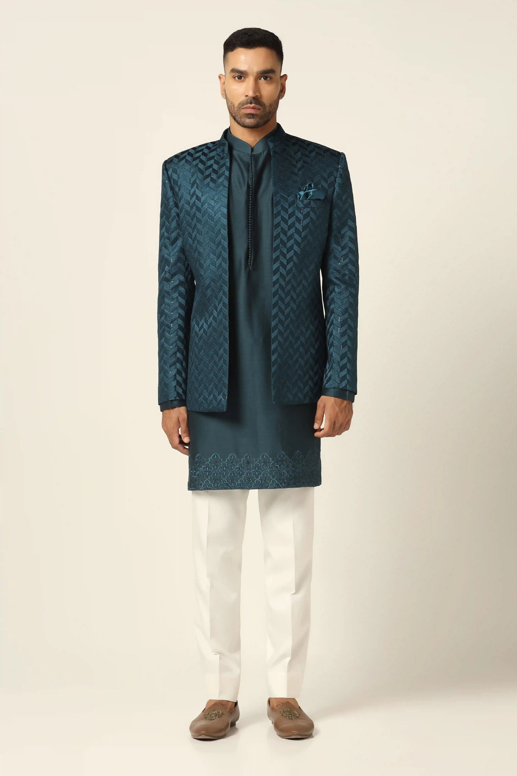 Elevate your style with a teal bandhgala suit, adorned with exquisite embroidery. Shop Now!