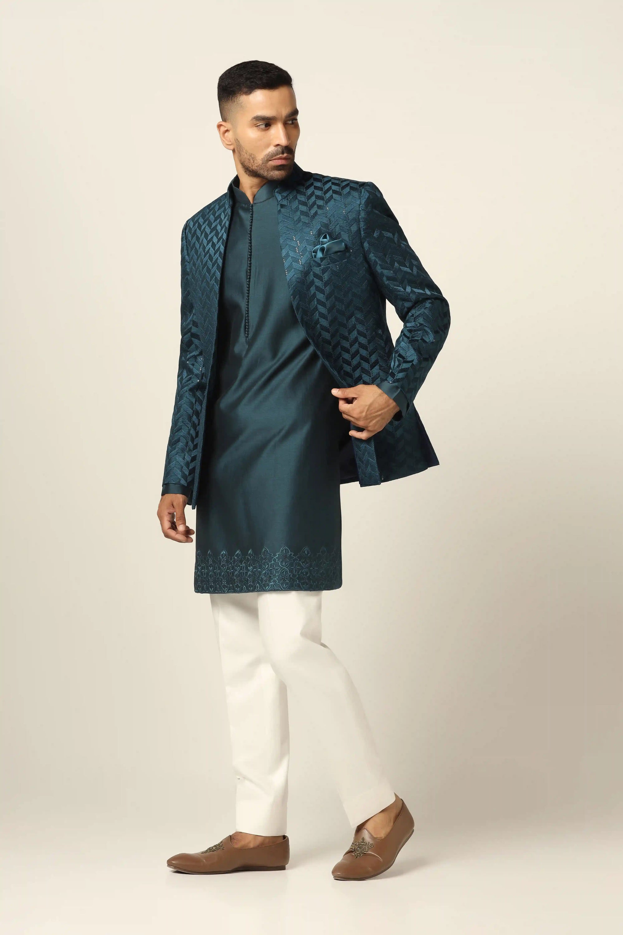 Elevate your style with a teal bandhgala suit, adorned with exquisite embroidery. Shop Now!