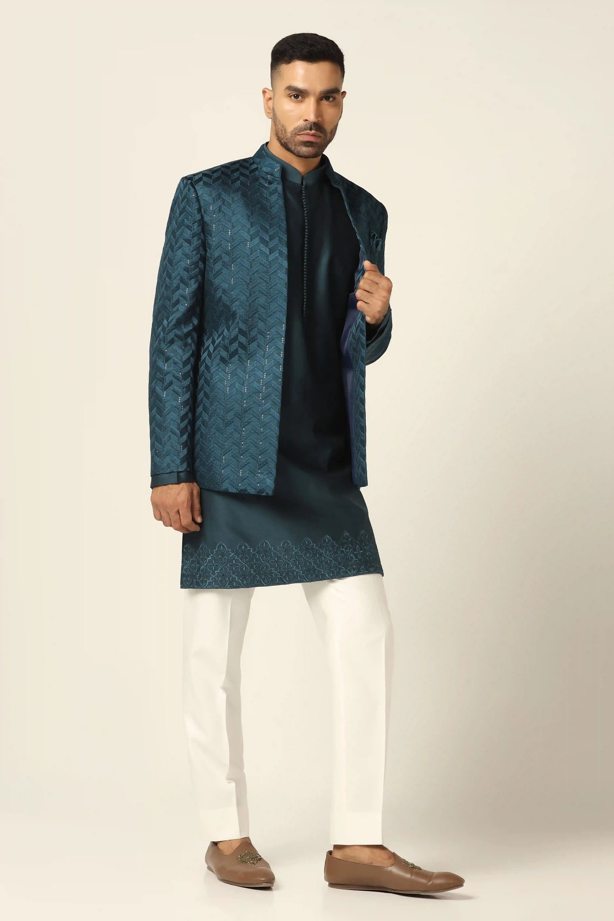 Elevate your style with a teal bandhgala suit, adorned with exquisite embroidery. Shop Now!
